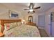 Spacious bedroom with floral comforter and ceiling fan at 1006 Mcdaniel St # 21, Sun City Center, FL 33573