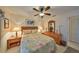 Bright bedroom with a floral comforter and ceiling fan at 1006 Mcdaniel St # 21, Sun City Center, FL 33573