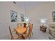Dining room with light wood table and six chairs at 1006 Mcdaniel St # 21, Sun City Center, FL 33573