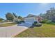 Side view of villa, showcasing garage and manicured landscaping at 1006 Mcdaniel St # 21, Sun City Center, FL 33573
