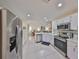 Stainless steel appliances and white cabinetry in this kitchen at 1006 Mcdaniel St # 21, Sun City Center, FL 33573