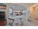 Modern kitchen with breakfast bar and white cabinets at 1006 Mcdaniel St # 21, Sun City Center, FL 33573
