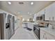 Modern kitchen with stainless steel appliances and white cabinets at 1006 Mcdaniel St # 21, Sun City Center, FL 33573