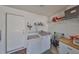 Convenient laundry room with washer, dryer, and storage shelves at 1006 Mcdaniel St # 21, Sun City Center, FL 33573