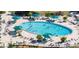 Large kidney-shaped pool with plenty of lounge chairs at 1006 Mcdaniel St # 21, Sun City Center, FL 33573