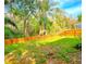 Private backyard with mature trees and wooden fence at 10232 Grant Creek Dr, Tampa, FL 33647