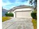 Tan house with a two-car garage and neatly trimmed hedges at 10232 Grant Creek Dr, Tampa, FL 33647