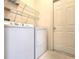 Laundry room with washer, dryer, and shelving units at 10232 Grant Creek Dr, Tampa, FL 33647