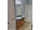 Clean bathroom with single sink vanity, toilet and bathtub at 1028 Tullamore Dr, Wesley Chapel, FL 33543