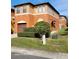 Two-story house with brown garage door and landscaping at 1028 Tullamore Dr, Wesley Chapel, FL 33543