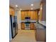 Kitchen with wood cabinets, stainless steel appliances, and flooring at 1028 Tullamore Dr, Wesley Chapel, FL 33543
