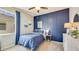 Serene bedroom with a blue accent wall and nautical-themed decor at 10818 Patoka Ter, Parrish, FL 34219