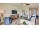 Cozy living room featuring a white sofa, blue accents, and shiplap wall at 10822 Patoka Ter, Parrish, FL 34219