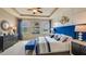 Main bedroom featuring a blue upholstered bed and stylish nightstands at 10822 Patoka Ter, Parrish, FL 34219