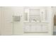 Double vanity bathroom with white cabinets and quartz countertops at 12661 Lily Quartz Loop, Parrish, FL 34219