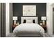 Bedroom with dark accent wall, queen bed, and wood nightstands at 12661 Lily Quartz Loop, Parrish, FL 34219