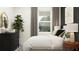 Bedroom with full bed, dark accent wall, and wood nightstand at 12661 Lily Quartz Loop, Parrish, FL 34219
