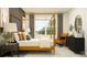 Spacious Primary bedroom with a canopy bed and dresser at 12661 Lily Quartz Loop, Parrish, FL 34219