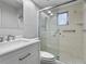 Updated bathroom with white vanity and a large glass shower at 1421 Normandy Park Dr # 2, Clearwater, FL 33756
