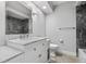 Modern bathroom with white vanity, marble countertops, and gray marble tile at 1421 Normandy Park Dr # 2, Clearwater, FL 33756