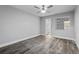 Spacious bedroom with ceiling fan and gray laminate wood flooring at 1421 Normandy Park Dr # 2, Clearwater, FL 33756