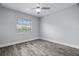 Bedroom with large window, ceiling fan, and gray flooring at 1421 Normandy Park Dr # 2, Clearwater, FL 33756