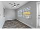 Cozy bedroom with window, ceiling fan, and gray flooring at 1421 Normandy Park Dr # 2, Clearwater, FL 33756