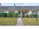 Inviting exterior of a ranch-style home featuring a walkway and landscaping at 1421 Normandy Park Dr # 2, Clearwater, FL 33756