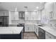 Updated kitchen with white cabinets, quartz countertops, and stainless steel appliances at 1421 Normandy Park Dr # 2, Clearwater, FL 33756