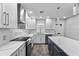 Renovated kitchen featuring white cabinets and expansive quartz countertops at 1421 Normandy Park Dr # 2, Clearwater, FL 33756