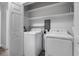 Bright laundry room with washer, dryer, and ample shelving at 1421 Normandy Park Dr # 2, Clearwater, FL 33756