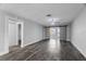 Spacious living room with gray walls, wood-look floors, and barn door at 1421 Normandy Park Dr # 2, Clearwater, FL 33756