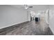 Open living area with gray walls, wood-look floors, and kitchen view at 1421 Normandy Park Dr # 2, Clearwater, FL 33756
