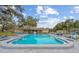 Community pool with lounge chairs, offering a relaxing outdoor space at 1421 Normandy Park Dr # 2, Clearwater, FL 33756