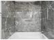 Clean shower with gray marble tile and a rain shower head at 1421 Normandy Park Dr # 2, Clearwater, FL 33756