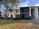 Exterior view of condo building with landscaping and walkway at 1433 Pine Glen Pl # G2, Tarpon Springs, FL 34688