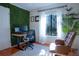 Home office with standing desk, comfortable chair, and leafy wall at 1433 Pine Glen Pl # G2, Tarpon Springs, FL 34688
