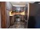 Modern kitchen with stainless steel appliances and wood cabinets at 1433 Pine Glen Pl # G2, Tarpon Springs, FL 34688