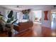 Living room with hardwood floors, couches, and access to balcony at 1433 Pine Glen Pl # G2, Tarpon Springs, FL 34688