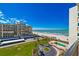 Aerial view of building, pool, and beach access at 1460 Gulf Blvd # 811, Clearwater Beach, FL 33767