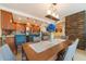 Elegant dining room with wood table and stone accent wall at 1460 Gulf Blvd # 811, Clearwater Beach, FL 33767