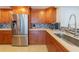 Modern kitchen with stainless steel appliances and wood cabinetry at 1460 Gulf Blvd # 811, Clearwater Beach, FL 33767