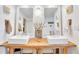 Bathroom featuring a rustic wood double vanity and white vessel sinks at 1520 Gulf Blvd # 603, Clearwater Beach, FL 33767