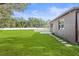 Home exterior with backyard patio and grassy lawn at 15571 Stone House Dr, Brooksville, FL 34604