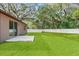 Spacious backyard with patio and lush lawn at 15571 Stone House Dr, Brooksville, FL 34604