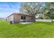 Home exterior view, backyard with patio and green grass at 15571 Stone House Dr, Brooksville, FL 34604