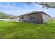 Home exterior, backyard features a patio and grassy area at 15571 Stone House Dr, Brooksville, FL 34604