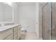 Clean bathroom with double vanity, granite countertop, and glass shower at 15571 Stone House Dr, Brooksville, FL 34604