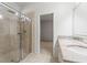 Bathroom with shower, double vanity, and granite countertop at 15571 Stone House Dr, Brooksville, FL 34604