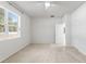 Primary bedroom with carpeted floor and large window with blinds at 15571 Stone House Dr, Brooksville, FL 34604